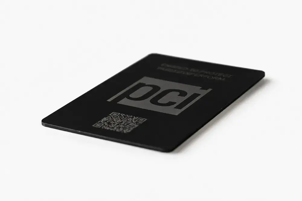 A company-branded Bümpis metal card angled in the light, its etched logo facing the camera